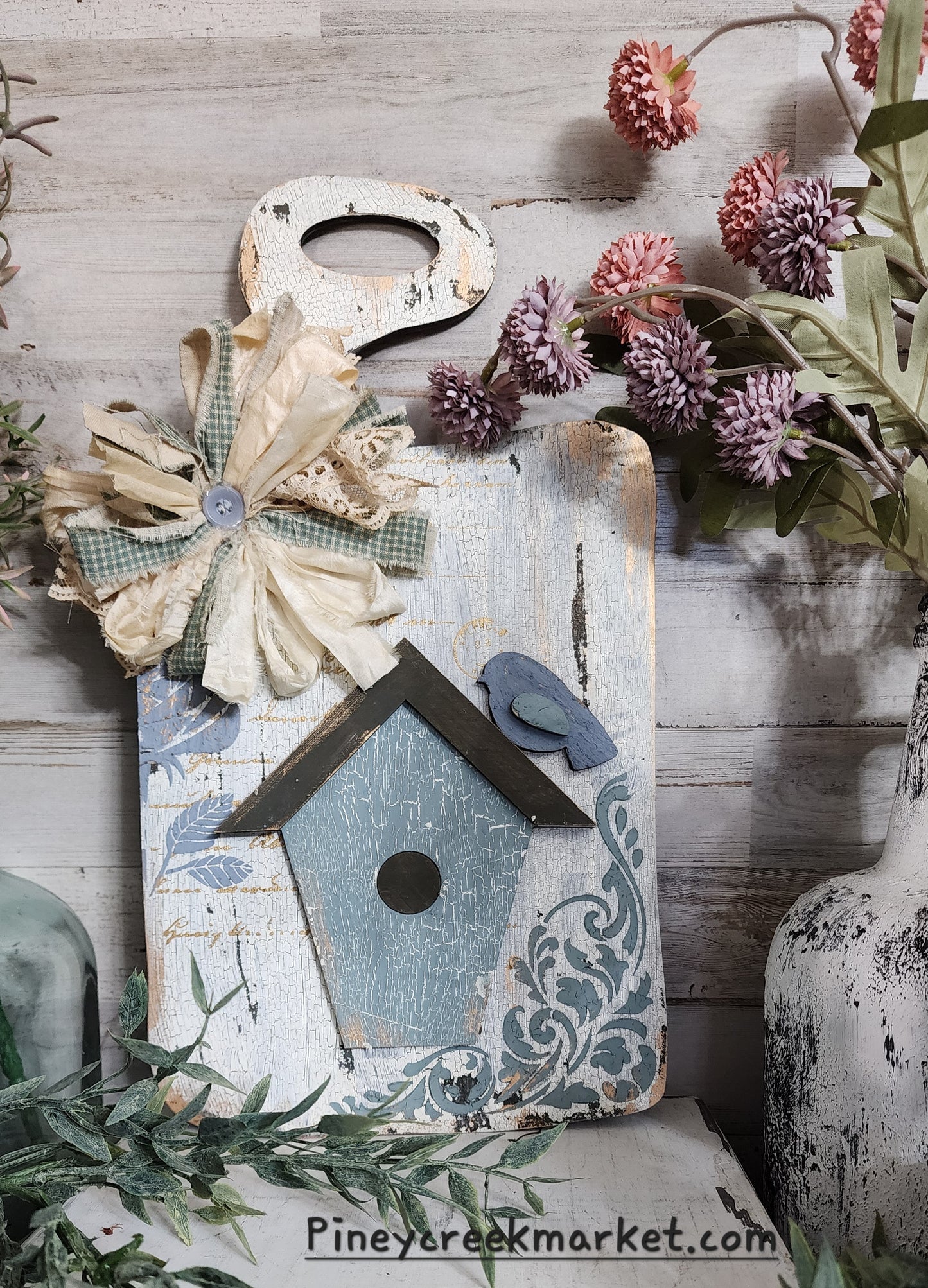 Hand drawn breadboard with bird and birdhouse cutouts